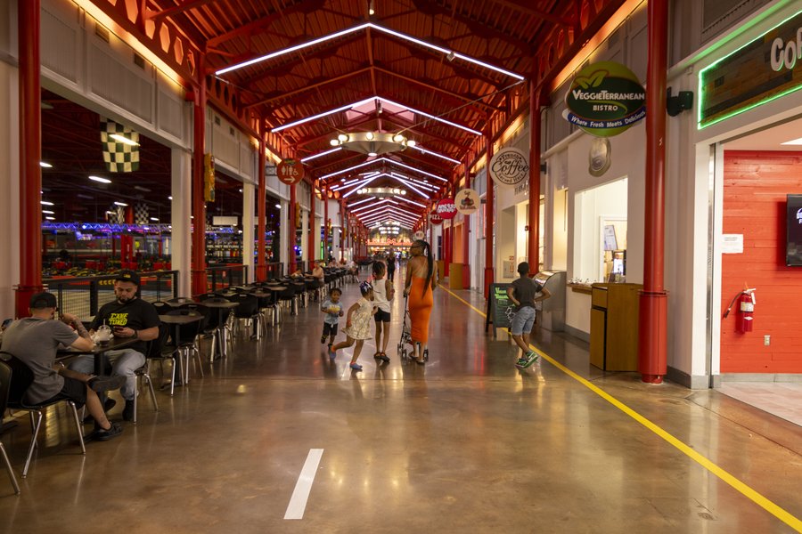 Families walking through the Dezerland Park dining corridor