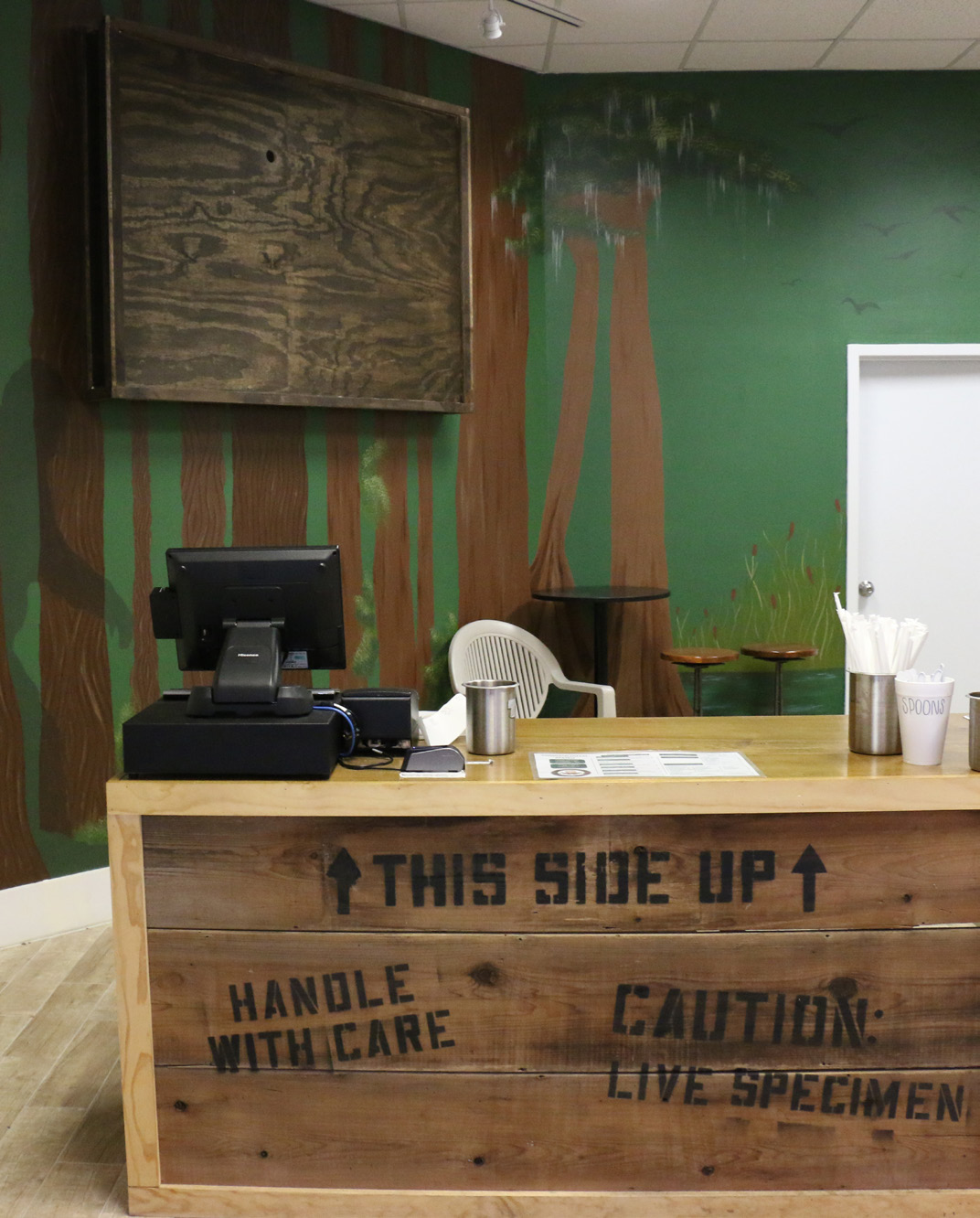 Sales counter inside Unit G20 with forest mural